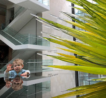 Elliot waving next to Dale Chihuly's Lime Green Icicle Tower at the MFA